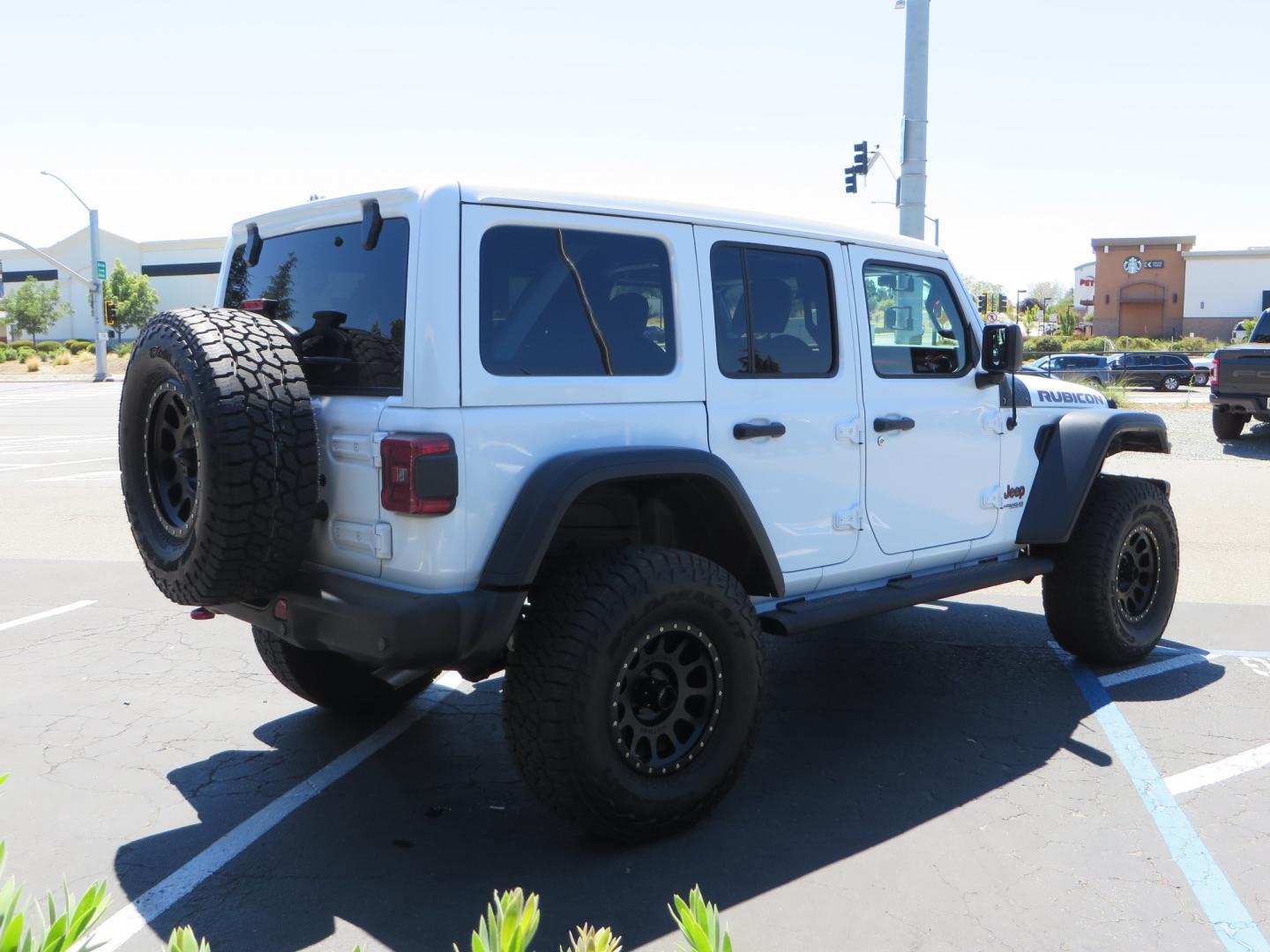 2021 White /BLACK Jeep Wrangler Unlimited Rubicon (1C4HJXFG1MW) with an 3.6L V6 DOHC 24V FFV engine, Manual 6 speed transmission, located at 2630 Grass Valley Highway, Auburn, CA, 95603, (530) 508-5100, 38.937893, -121.095482 - This manual transmission Rubicon is set up with a Mopar suspension systems, Fox shocks, 17" Method Race wheels, and 35" Falken Wildpeak AT3W tires. - Photo#4