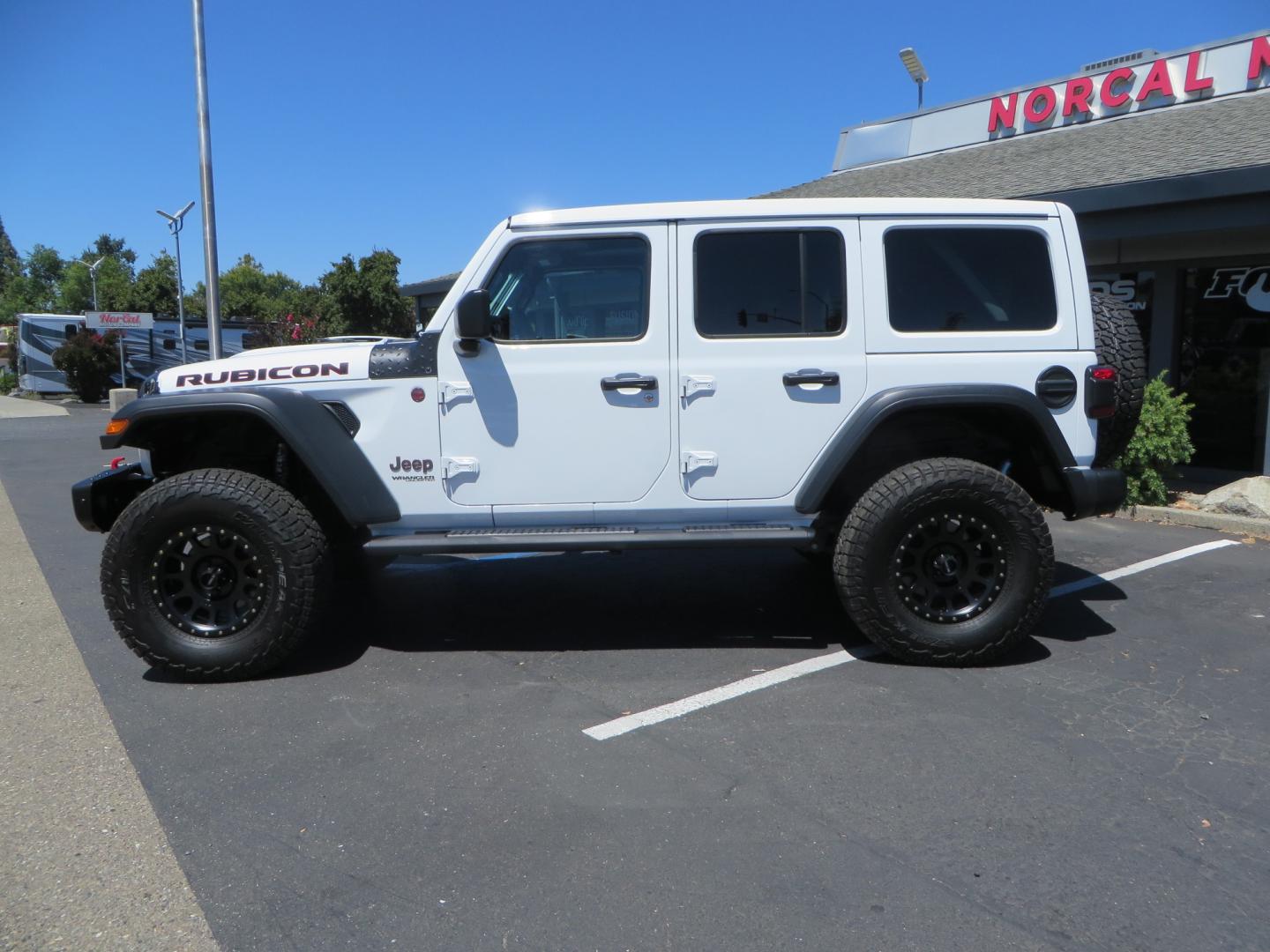 2021 White /BLACK Jeep Wrangler Unlimited Rubicon (1C4HJXFG1MW) with an 3.6L V6 DOHC 24V FFV engine, Manual 6 speed transmission, located at 2630 Grass Valley Highway, Auburn, CA, 95603, (530) 508-5100, 38.937893, -121.095482 - This manual transmission Rubicon is set up with a Mopar suspension systems, Fox shocks, 17" Method Race wheels, and 35" Falken Wildpeak AT3W tires. - Photo#7