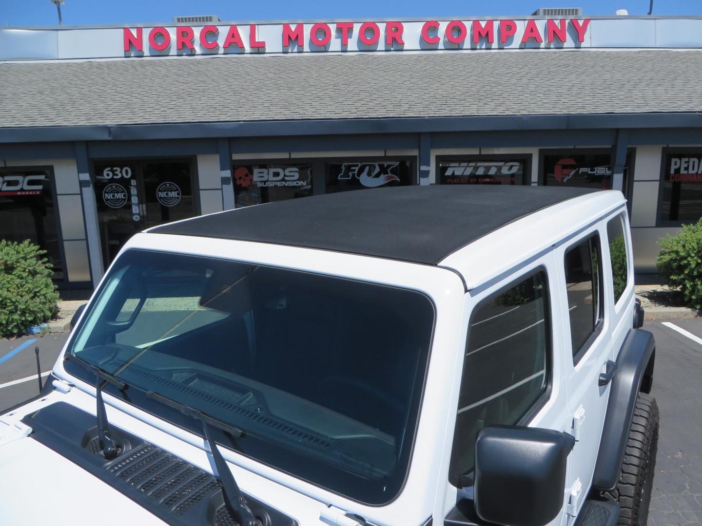 2021 White /BLACK Jeep Wrangler Unlimited Rubicon (1C4HJXFG1MW) with an 3.6L V6 DOHC 24V FFV engine, Manual 6 speed transmission, located at 2630 Grass Valley Highway, Auburn, CA, 95603, (530) 508-5100, 38.937893, -121.095482 - This manual transmission Rubicon is set up with a Mopar suspension systems, Fox shocks, 17" Method Race wheels, and 35" Falken Wildpeak AT3W tires. - Photo#11