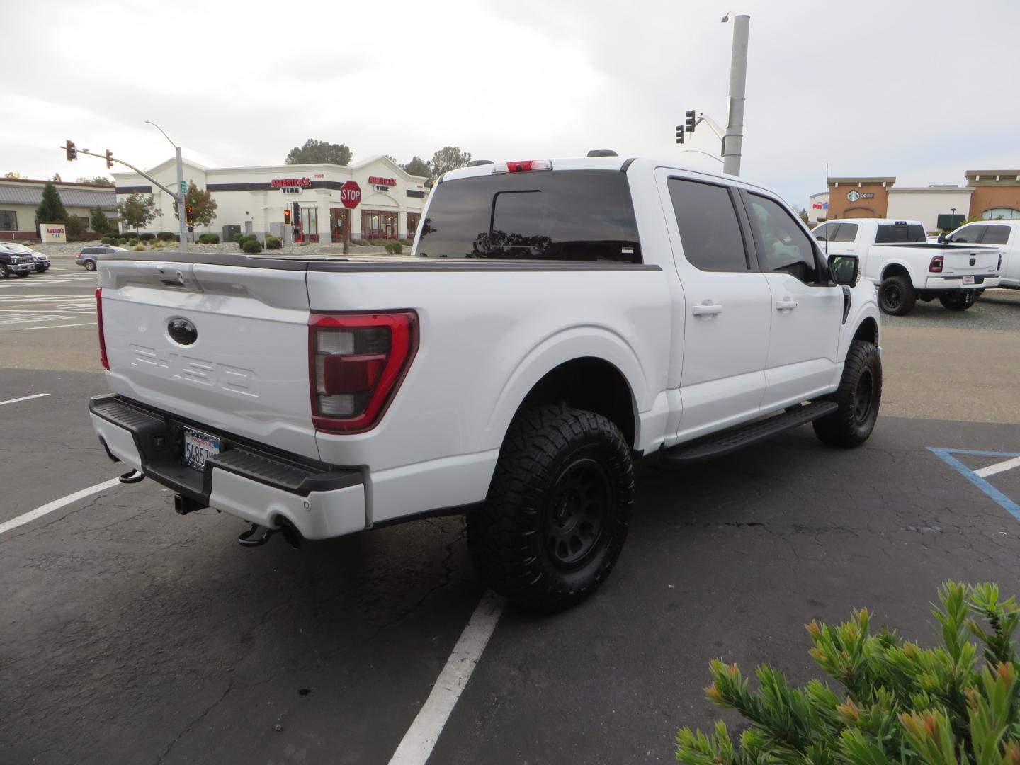 2022 White /black Ford F-150 Tremor SuperCrew 5.5-ft. Bed 4WD (1FTEW1E82NF) with an 3.5L V6 TURBO engine, 10 speed transmission, located at 2630 Grass Valley Highway, Auburn, CA, 95603, (530) 508-5100, 38.937893, -121.095482 - Tremor F150 Featuring an Icon Vehicle Dynamics stage 4 suspension system, 17" Method NV doubl eblack wheels, Nitto Ridge Grappler tires, Bakflip MX4, window tint, and custom paint to eliminate the Tremor orange and blue Ford emblems. - Photo#4