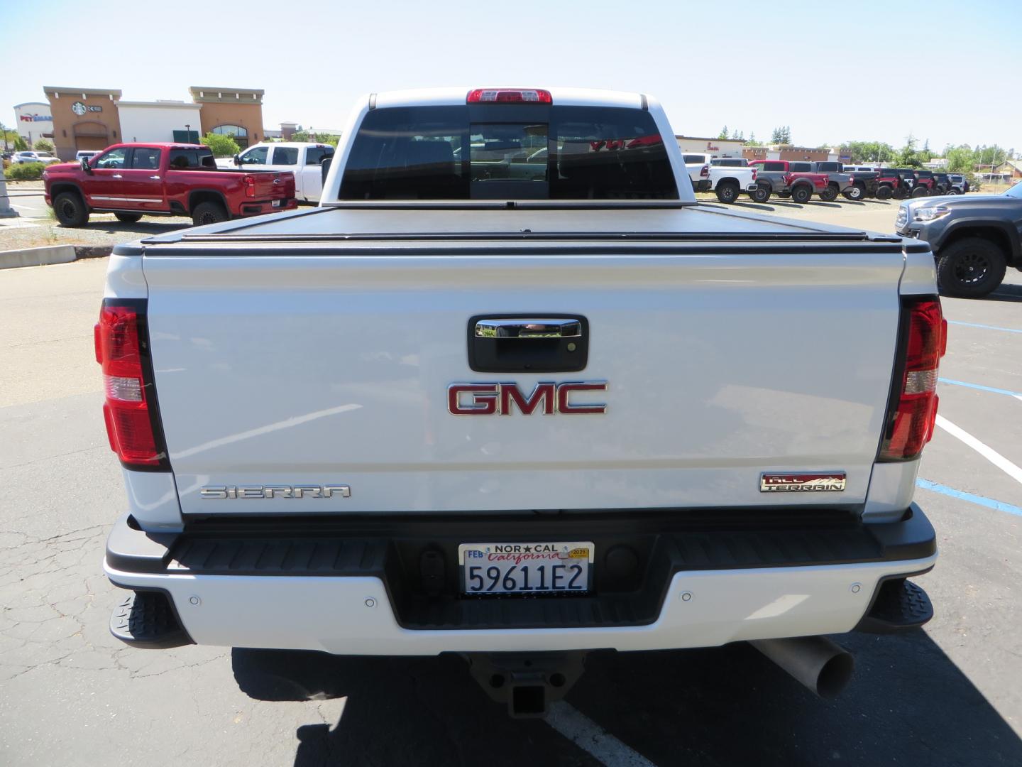 2017 White /BLACK GMC Sierra 3500HD SLT Crew Cab 4WD (1GT42XCY4HF) with an 6.6L V8 OHV 16 DIESEL engine, 6A transmission, located at 2630 Grass Valley Highway, Auburn, CA, 95603, (530) 508-5100, 38.937893, -121.095482 - Lifted GMC Duramax with Fox remote reservoir shocks, AMP Power steps, Rool N Lock tonneau cover, 20" Hostile Gauntlet wheels, BFG KO2 tires, all weather floor mats, window tint, and headrest DVD players. - Photo#5