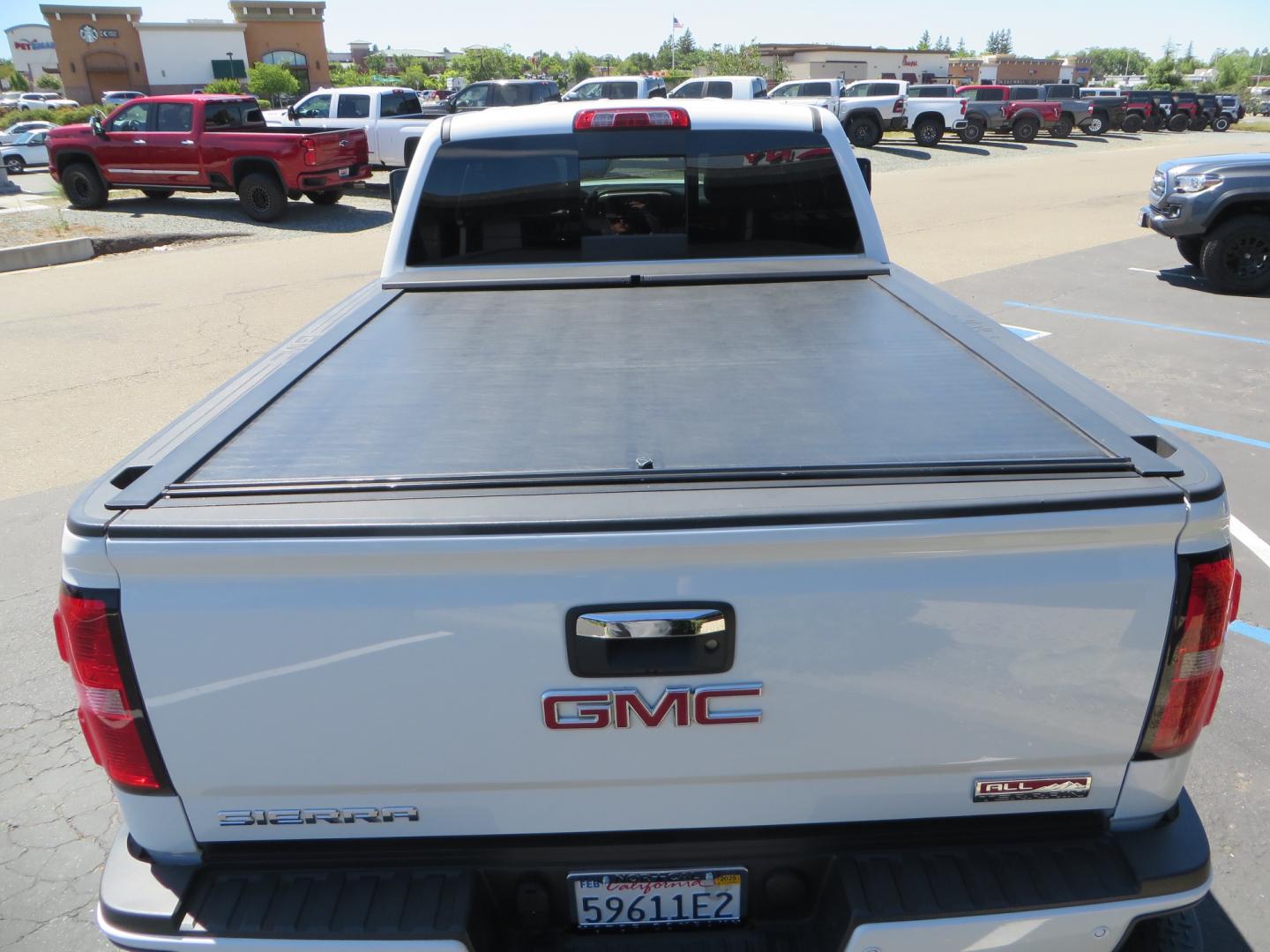 2017 White /BLACK GMC Sierra 3500HD SLT Crew Cab 4WD (1GT42XCY4HF) with an 6.6L V8 OHV 16 DIESEL engine, 6A transmission, located at 2630 Grass Valley Highway, Auburn, CA, 95603, (530) 508-5100, 38.937893, -121.095482 - Lifted GMC Duramax with Fox remote reservoir shocks, AMP Power steps, Rool N Lock tonneau cover, 20" Hostile Gauntlet wheels, BFG KO2 tires, all weather floor mats, window tint, and headrest DVD players. - Photo#12