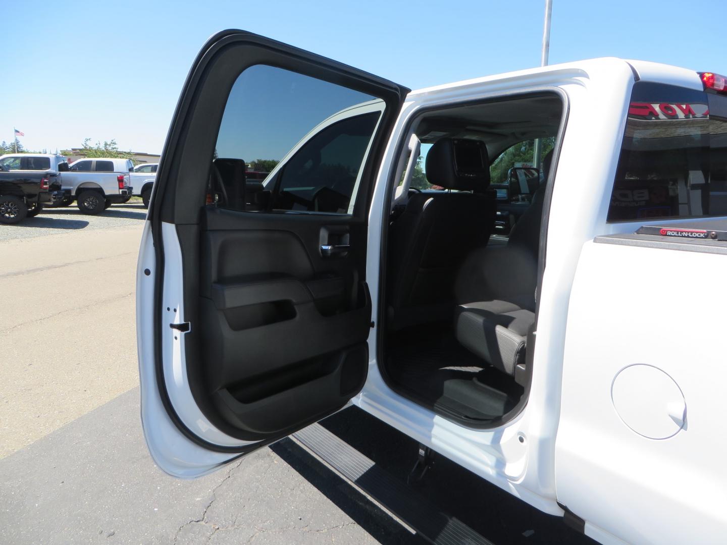 2017 White /BLACK GMC Sierra 3500HD SLT Crew Cab 4WD (1GT42XCY4HF) with an 6.6L V8 OHV 16 DIESEL engine, 6A transmission, located at 2630 Grass Valley Highway, Auburn, CA, 95603, (530) 508-5100, 38.937893, -121.095482 - Lifted GMC Duramax with Fox remote reservoir shocks, AMP Power steps, Rool N Lock tonneau cover, 20" Hostile Gauntlet wheels, BFG KO2 tires, all weather floor mats, window tint, and headrest DVD players. - Photo#35