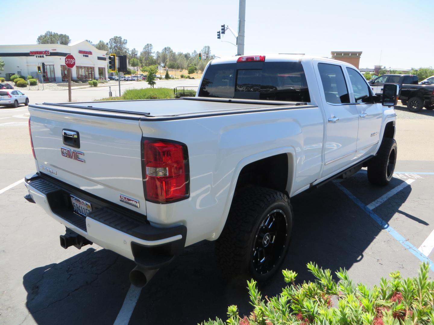 2017 White /BLACK GMC Sierra 3500HD SLT Crew Cab 4WD (1GT42XCY4HF) with an 6.6L V8 OHV 16 DIESEL engine, 6A transmission, located at 2630 Grass Valley Highway, Auburn, CA, 95603, (530) 508-5100, 38.937893, -121.095482 - Lifted GMC Duramax with Fox remote reservoir shocks, AMP Power steps, Rool N Lock tonneau cover, 20" Hostile Gauntlet wheels, BFG KO2 tires, all weather floor mats, window tint, and headrest DVD players. - Photo#4