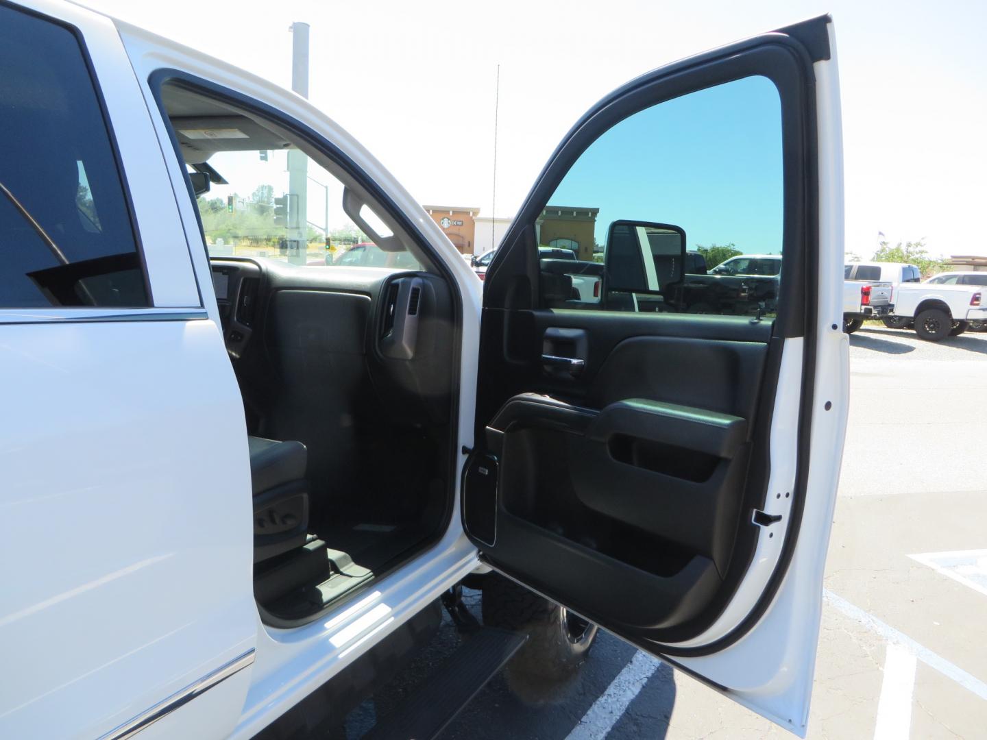 2017 White /BLACK GMC Sierra 3500HD SLT Crew Cab 4WD (1GT42XCY4HF) with an 6.6L V8 OHV 16 DIESEL engine, 6A transmission, located at 2630 Grass Valley Highway, Auburn, CA, 95603, (530) 508-5100, 38.937893, -121.095482 - Lifted GMC Duramax with Fox remote reservoir shocks, AMP Power steps, Rool N Lock tonneau cover, 20" Hostile Gauntlet wheels, BFG KO2 tires, all weather floor mats, window tint, and headrest DVD players. - Photo#42