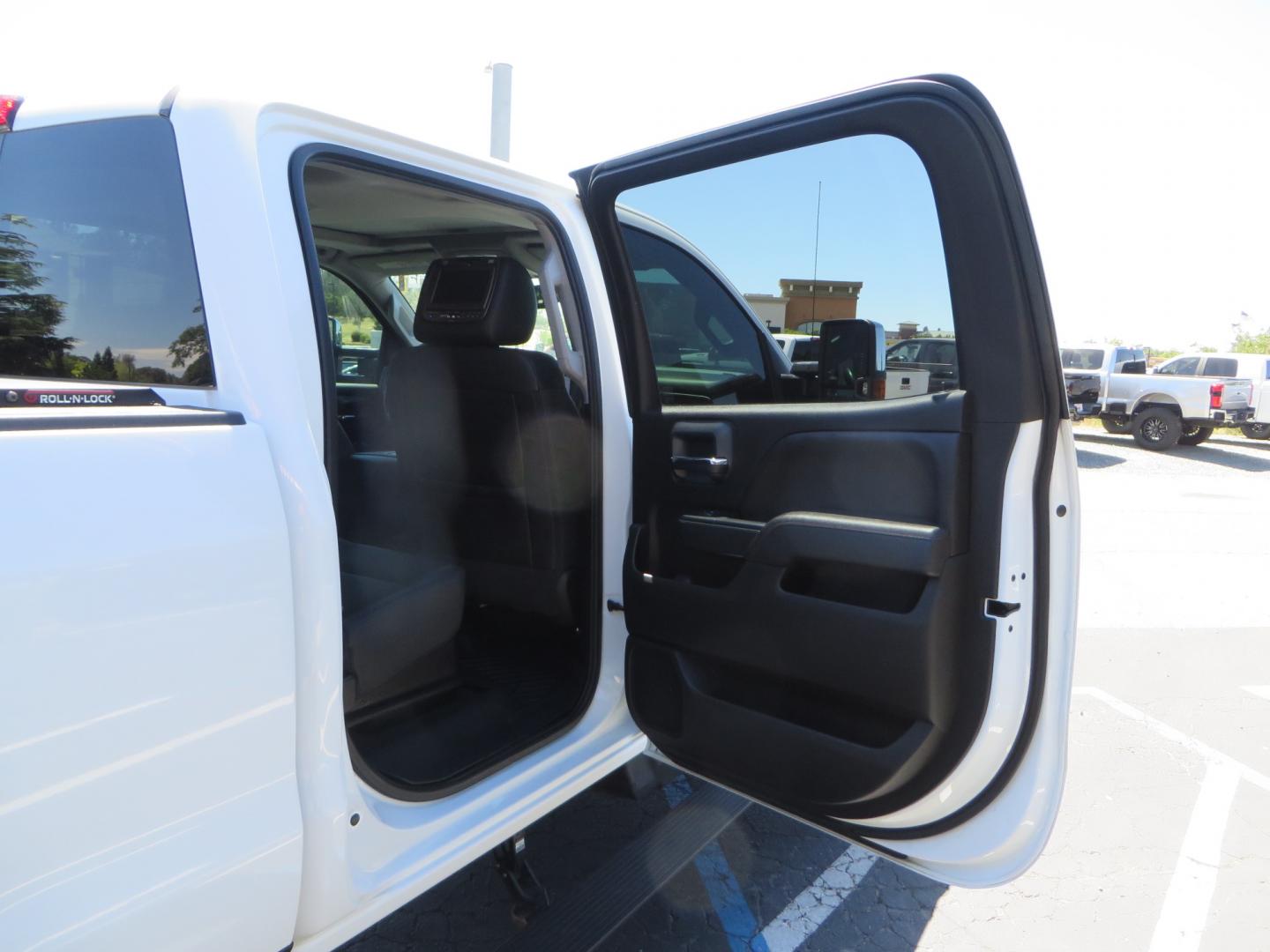 2017 White /BLACK GMC Sierra 3500HD SLT Crew Cab 4WD (1GT42XCY4HF) with an 6.6L V8 OHV 16 DIESEL engine, 6A transmission, located at 2630 Grass Valley Highway, Auburn, CA, 95603, (530) 508-5100, 38.937893, -121.095482 - Lifted GMC Duramax with Fox remote reservoir shocks, AMP Power steps, Rool N Lock tonneau cover, 20" Hostile Gauntlet wheels, BFG KO2 tires, all weather floor mats, window tint, and headrest DVD players. - Photo#48