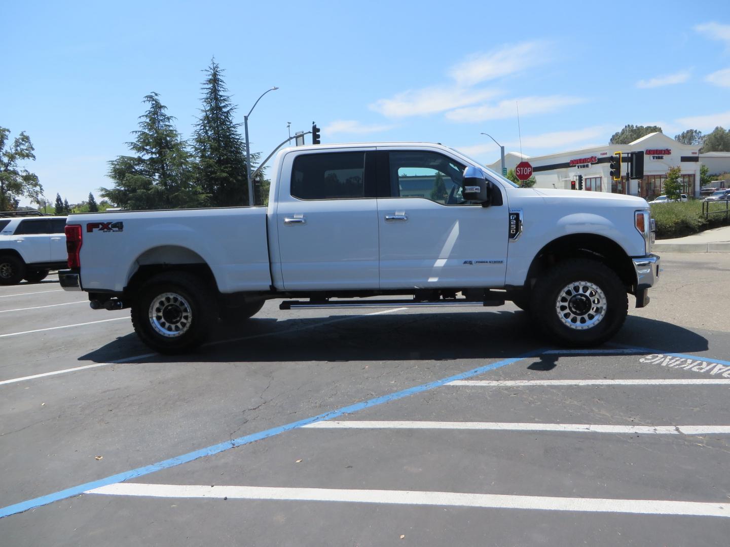 2017 White Ford F-250 SD Lariat Crew Cab Short Bed 4WD (1FT7W2BT4HE) with an 6.7L V8 OHV 16V DIESEL engine, 6A transmission, located at 2630 Grass Valley Highway, Auburn, CA, 95603, (530) 508-5100, 38.937893, -121.095482 - Leveled F250 sitting on brand new 17" Method Race wheels and Nitto Recon Grappler tires. - Photo#3