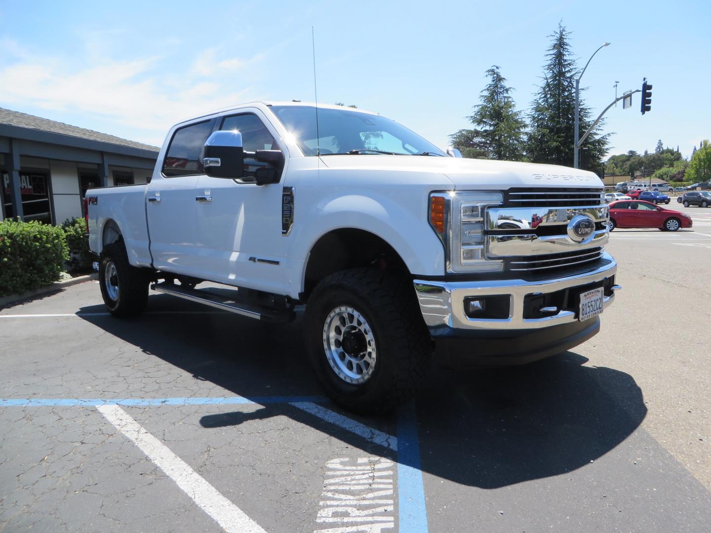 2017 White Ford F-250 SD Lariat Crew Cab Short Bed 4WD (1FT7W2BT4HE) with an 6.7L V8 OHV 16V DIESEL engine, 6A transmission, located at 2630 Grass Valley Highway, Auburn, CA, 95603, (530) 508-5100, 38.937893, -121.095482 - Leveled F250 sitting on brand new 17" Method Race wheels and Nitto Recon Grappler tires. - Photo#2