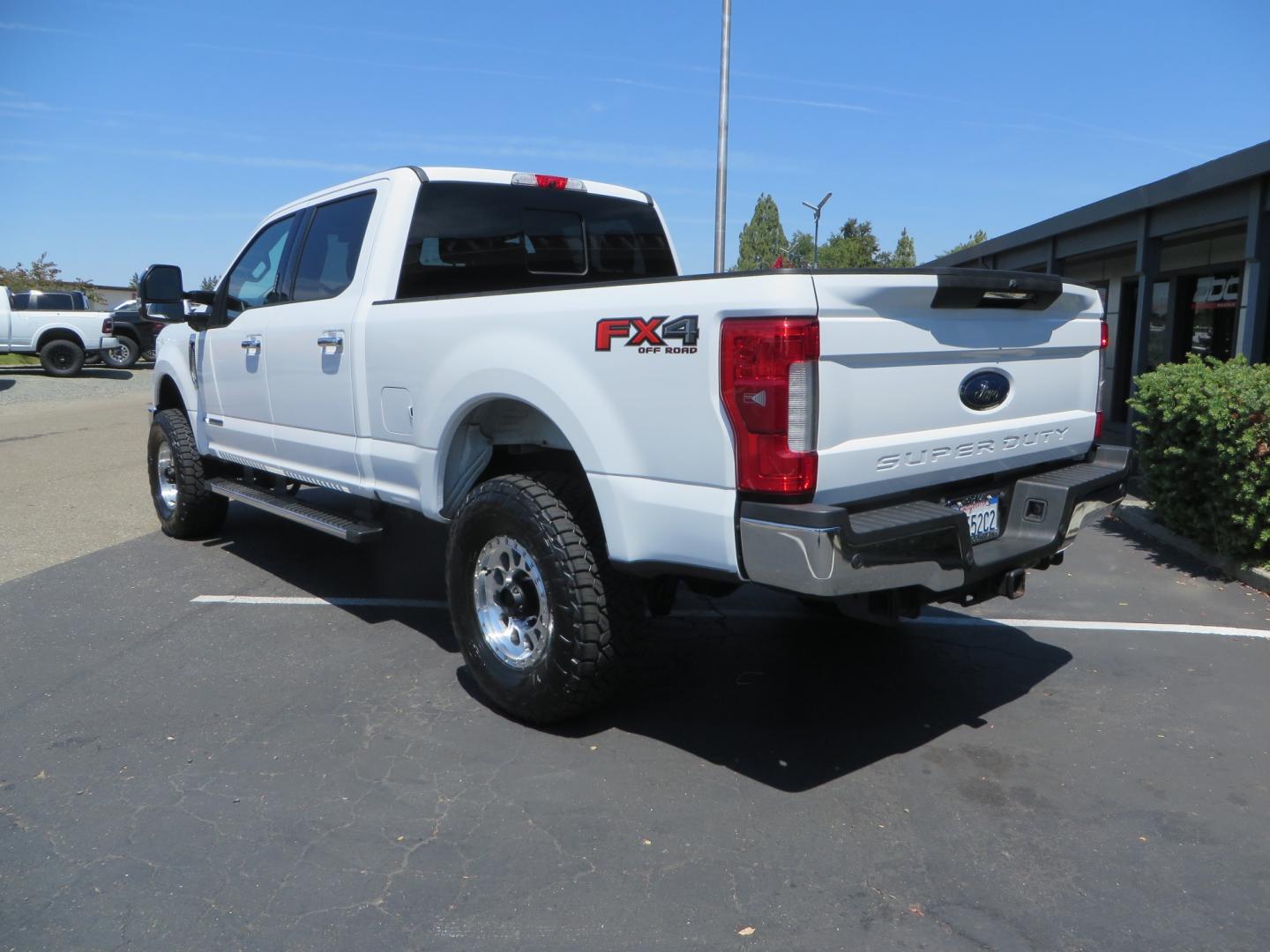 2017 White Ford F-250 SD Lariat Crew Cab Short Bed 4WD (1FT7W2BT4HE) with an 6.7L V8 OHV 16V DIESEL engine, 6A transmission, located at 2630 Grass Valley Highway, Auburn, CA, 95603, (530) 508-5100, 38.937893, -121.095482 - Leveled F250 sitting on brand new 17" Method Race wheels and Nitto Recon Grappler tires. - Photo#5