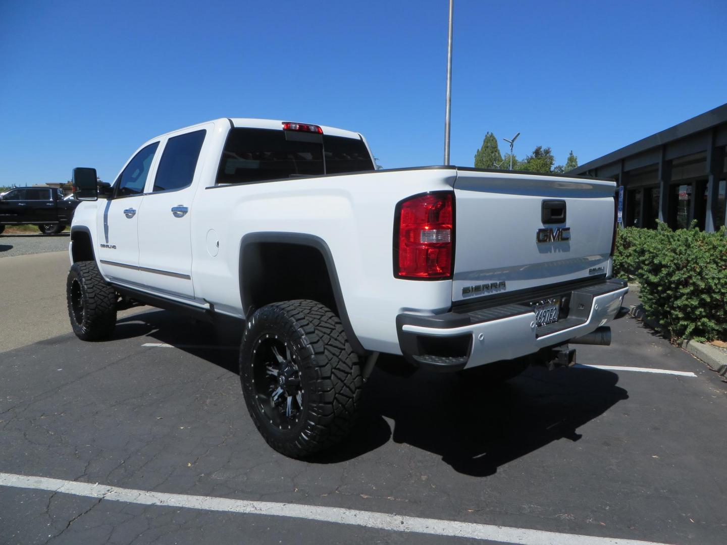 2016 GMC Sierra 2500HD Denali Crew Cab 4WD (1GT12UE8XGF) with an 6.6L V8 OHV 16 DIESEL engine, 6A transmission, located at 2630 Grass Valley Highway, Auburn, CA, 95603, (530) 508-5100, 38.937893, -121.095482 - Lifted Denali 2500 featuring a Pro Comp 6" lift kit, 20" Fuel Nutz wheels, 35" Nitto Ridge Grappler tires, Amp power steps, and Weathertech floor liners. - Photo#5