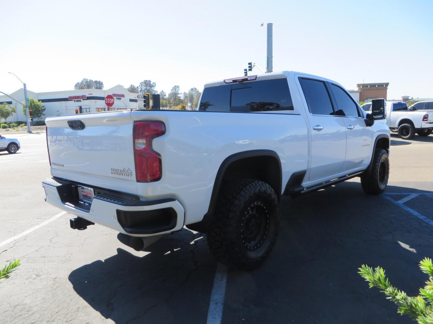 2021 White Chevrolet Silverado 2500HD High Country Crew Cab Short Box 4WD (1GC4YREY9MF) with an 6.6L V8 OHV 16V DIESEL engine, 6A transmission, located at 2630 Grass Valley Highway, Auburn, CA, 95603, (530) 508-5100, 38.937893, -121.095482 - Features - Fabtech leveling kit with upper control arms, 17" Method Race Wheels, 35" Toyo RT trail tires, and window tint. - Photo#3