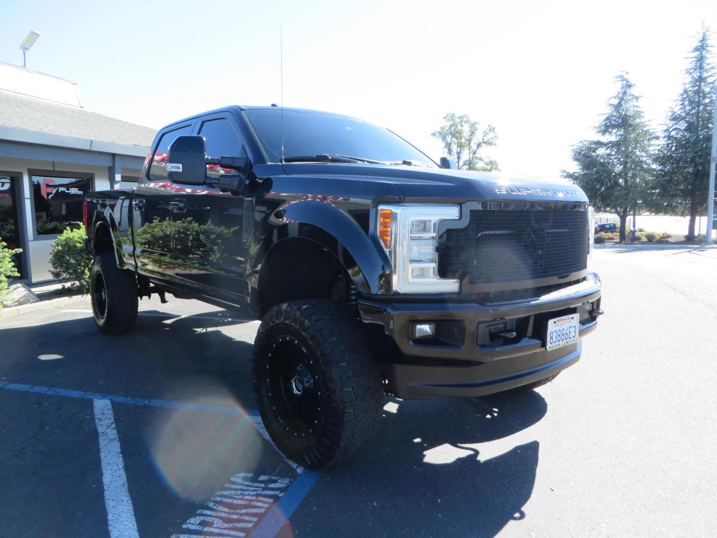 2017 BLACK Ford F-250 SD Platinum Crew Cab Short Bed 4WD (1FT7W2BT0HE) with an 6.7L V8 OHV 16V DIESEL engine, 6A transmission, located at 2630 Grass Valley Highway, Auburn, CA, 95603, (530) 508-5100, 38.937893, -121.095482 - Lifted F-250 featuring a SkyJacker long arm suspension system, Fox 2.5 remote reservoir coilovers, Fox 2.0 rear remote reservoir shocks, Fox dual steering stabilizers, 20" XD wheels, 37" Nitto Ridge Grappler tires, Racer X Mesh Grille, Airlift Air Bags, Painted badges, and window tint. - Photo#2