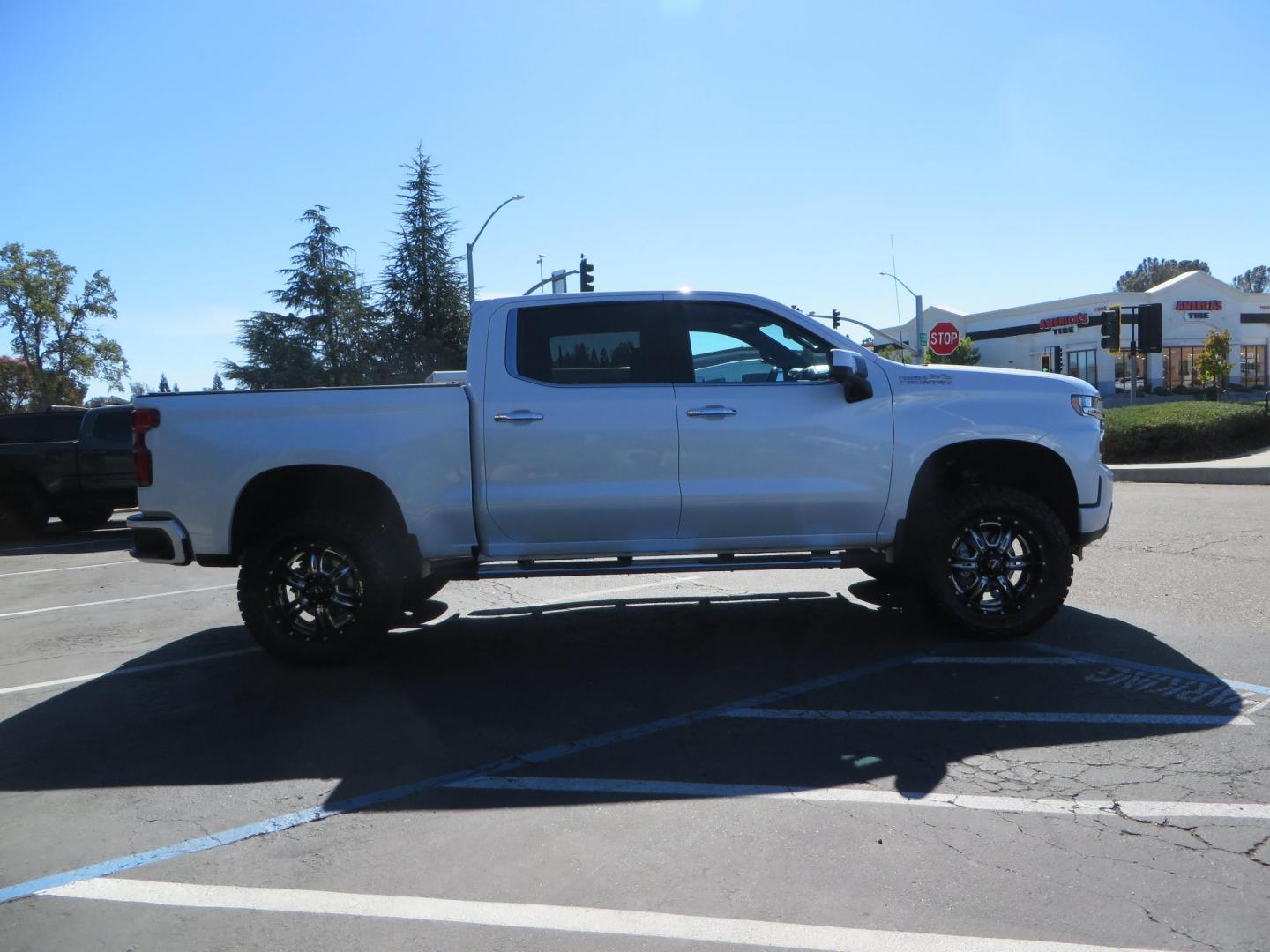 2021 White Chevrolet Silverado 1500 High Country Crew Cab 4WD (3GCUYHEL2MG) with an 6.2L V8 OHV 16V engine, 6A transmission, located at 2630 Grass Valley Highway, Auburn, CA, 95603, (530) 508-5100, 38.937893, -121.095482 - Features - Zone Offroad 6" lift kit, 35" Nitto Ridge Grappler tires, 20" SOTA wheels, and a Bakflip MX4 bedcover. - Photo#3