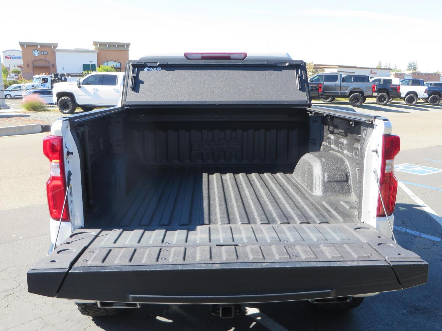 2021 White Chevrolet Silverado 1500 High Country Crew Cab 4WD (3GCUYHEL2MG) with an 6.2L V8 OHV 16V engine, 6A transmission, located at 2630 Grass Valley Highway, Auburn, CA, 95603, (530) 508-5100, 38.937893, -121.095482 - Features - Zone Offroad 6" lift kit, 35" Nitto Ridge Grappler tires, 20" SOTA wheels, and a Bakflip MX4 bedcover. - Photo#15