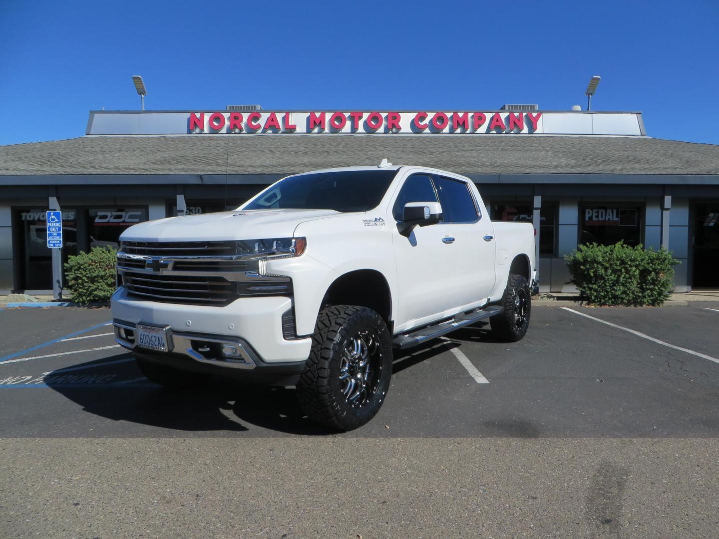 2021 White Chevrolet Silverado 1500 High Country Crew Cab 4WD (3GCUYHEL2MG) with an 6.2L V8 OHV 16V engine, 6A transmission, located at 2630 Grass Valley Highway, Auburn, CA, 95603, (530) 508-5100, 38.937893, -121.095482 - Features - Zone Offroad 6" lift kit, 35" Nitto Ridge Grappler tires, 20" SOTA wheels, and a Bakflip MX4 bedcover. - Photo#0