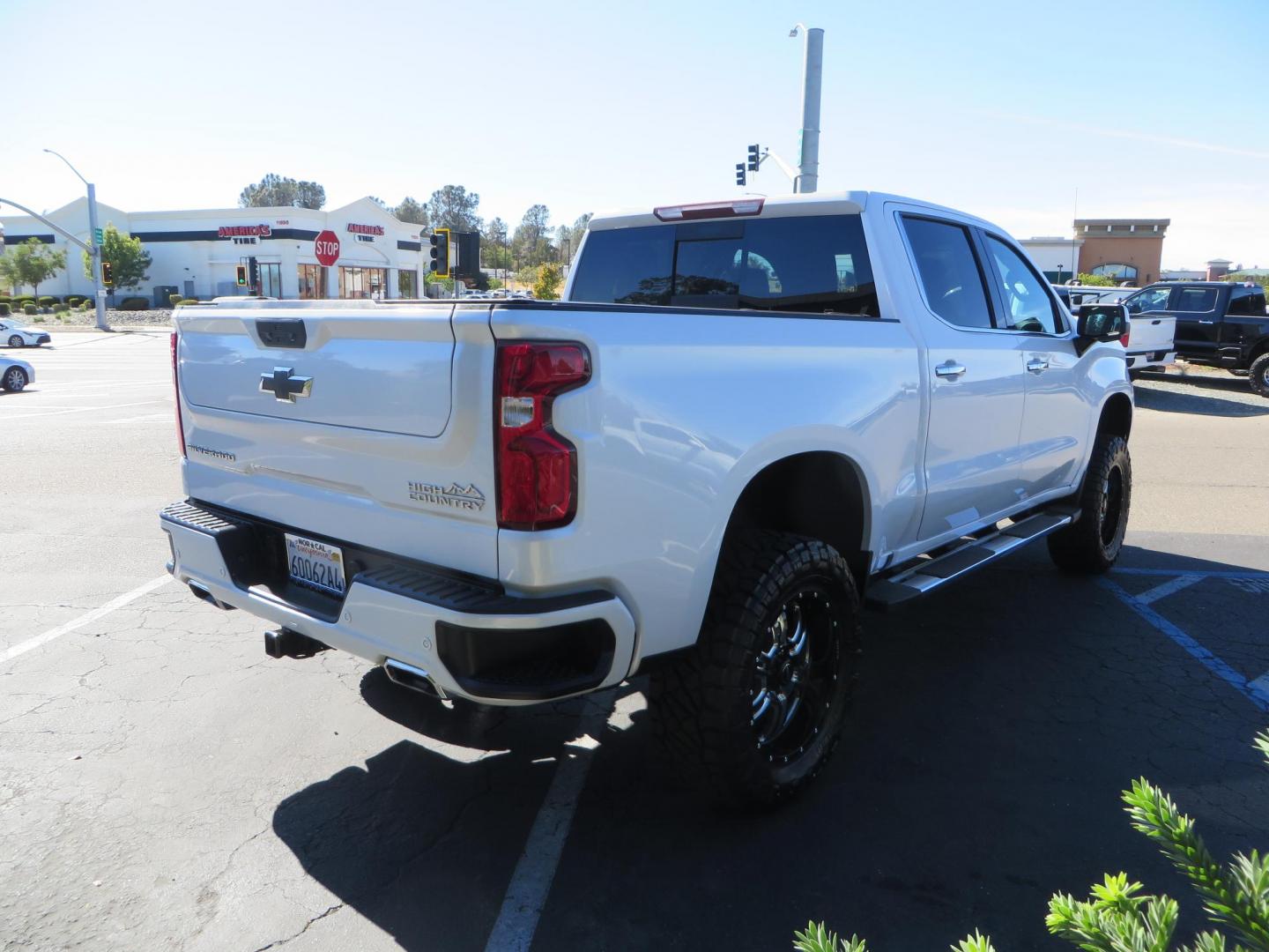 2021 White Chevrolet Silverado 1500 High Country Crew Cab 4WD (3GCUYHEL2MG) with an 6.2L V8 OHV 16V engine, 6A transmission, located at 2630 Grass Valley Highway, Auburn, CA, 95603, (530) 508-5100, 38.937893, -121.095482 - Features - Zone Offroad 6" lift kit, 35" Nitto Ridge Grappler tires, 20" SOTA wheels, and a Bakflip MX4 bedcover. - Photo#4