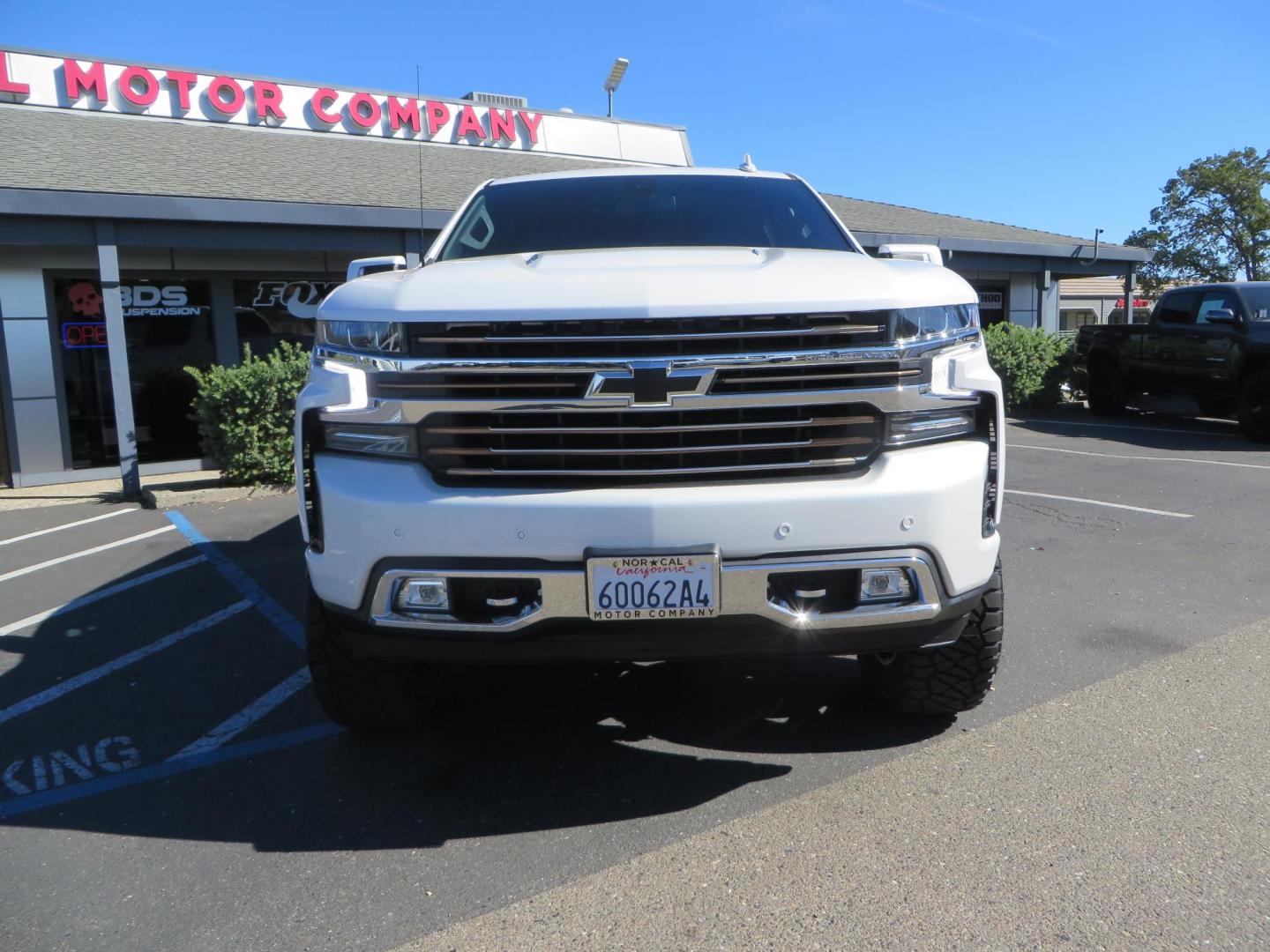 2021 White Chevrolet Silverado 1500 High Country Crew Cab 4WD (3GCUYHEL2MG) with an 6.2L V8 OHV 16V engine, 6A transmission, located at 2630 Grass Valley Highway, Auburn, CA, 95603, (530) 508-5100, 38.937893, -121.095482 - Features - Zone Offroad 6" lift kit, 35" Nitto Ridge Grappler tires, 20" SOTA wheels, and a Bakflip MX4 bedcover. - Photo#1