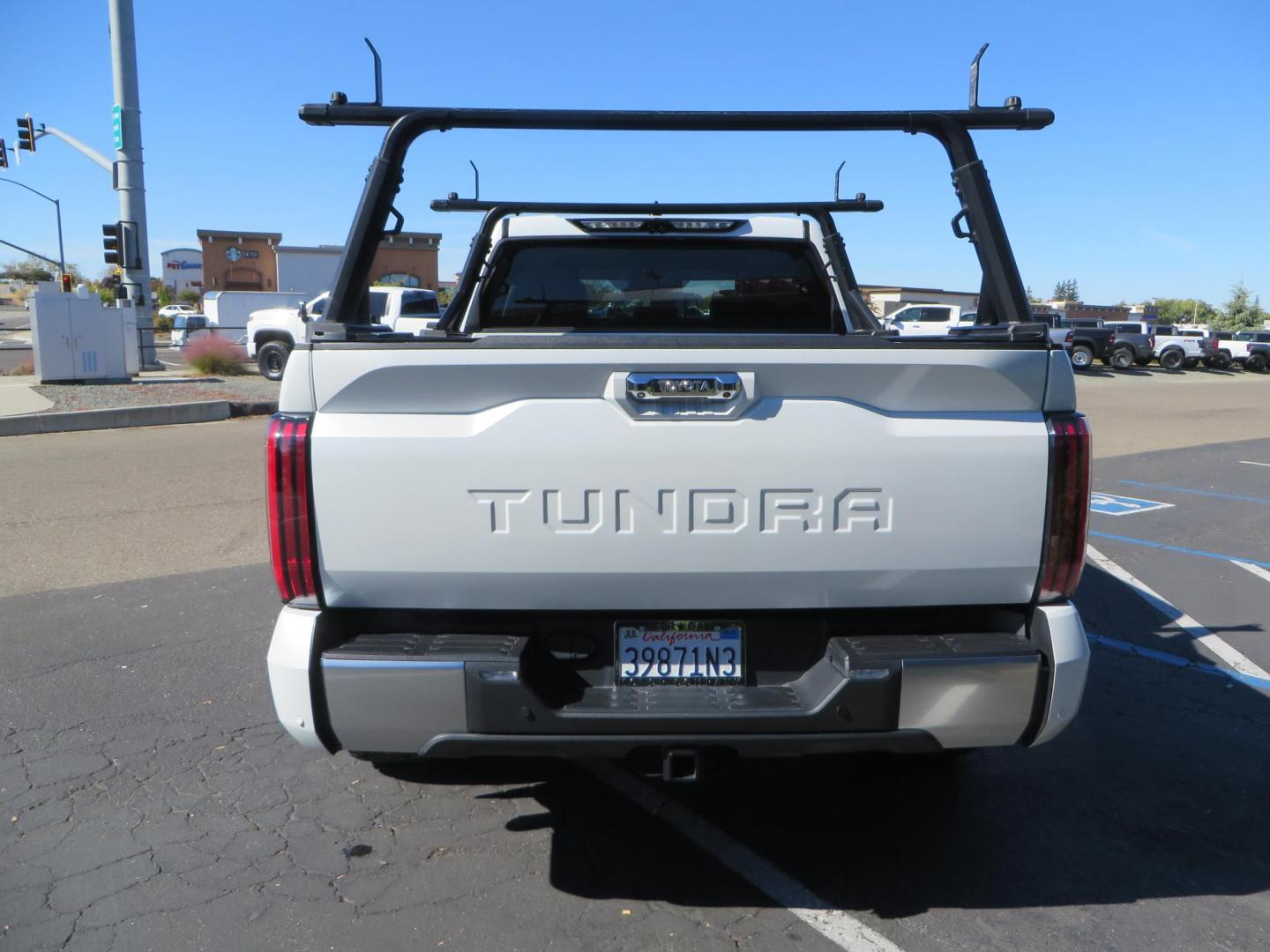 2022 White Toyota Tundra Limited CrewMax 2WD (5TFJA5AB0NX) with an 3.5L V6 DOHC 24V engine, 6A transmission, located at 2630 Grass Valley Highway, Auburn, CA, 95603, (530) 508-5100, 38.937893, -121.095482 - Tundra featuring a 2" leveling kit, 35" Nitto Ridge Grappler tires, 18" KMC IMS wheels, Retrax tonneau cover, and Yakima truck bed ladder rack. - Photo#5