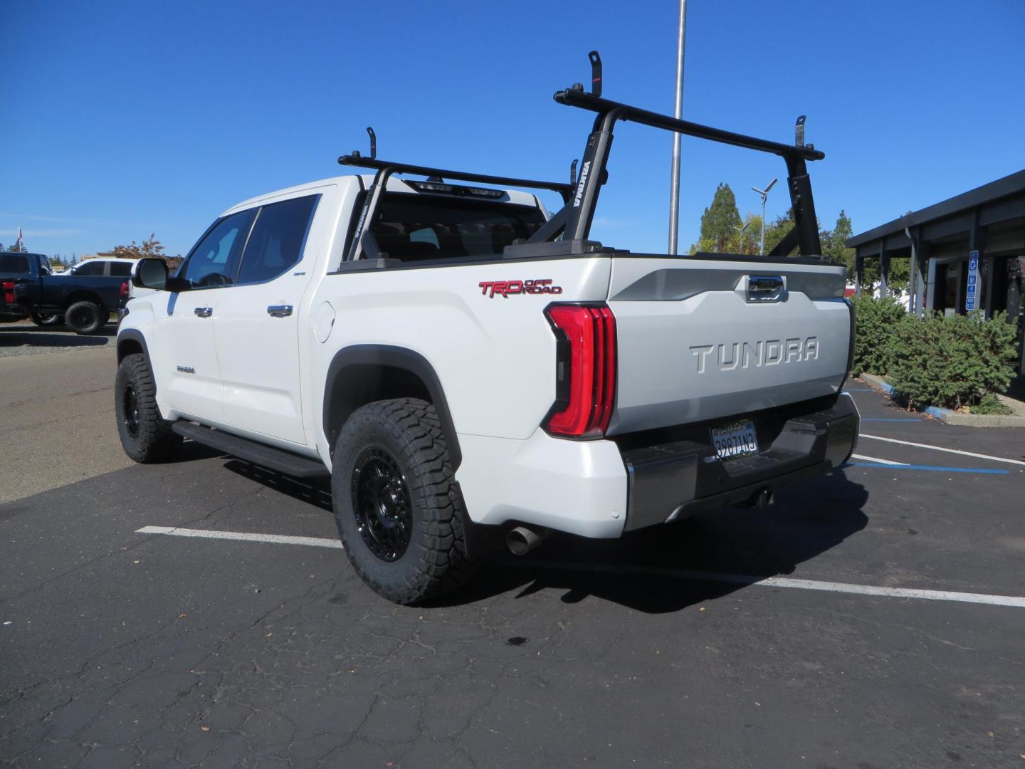 2022 White Toyota Tundra Limited CrewMax 2WD (5TFJA5AB0NX) with an 3.5L V6 DOHC 24V engine, 6A transmission, located at 2630 Grass Valley Highway, Auburn, CA, 95603, (530) 508-5100, 38.937893, -121.095482 - Tundra featuring a 2" leveling kit, 35" Nitto Ridge Grappler tires, 18" KMC IMS wheels, Retrax tonneau cover, and Yakima truck bed ladder rack. - Photo#6