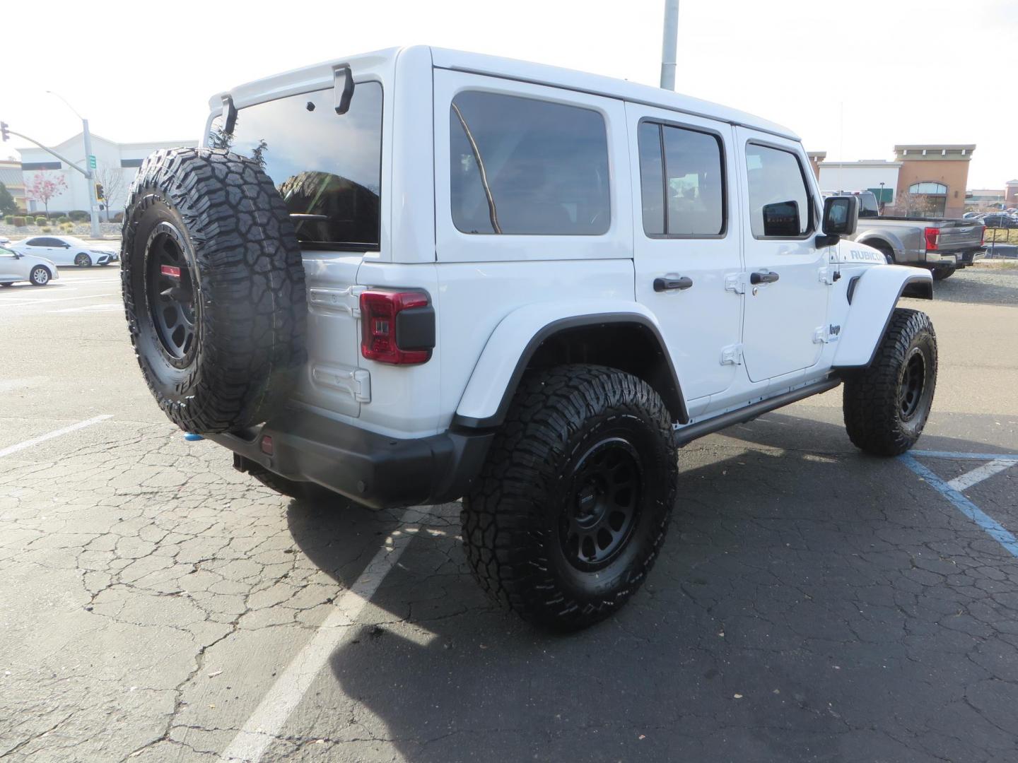 2021 White Jeep Wrangler Unlimited Rubicon 4XE (1C4JJXR62MW) with an 2.0L L4 DOHC 16V HYBRID engine, 8A transmission, located at 2630 Grass Valley Highway, Auburn, CA, 95603, (530) 508-5100, 38.937893, -121.095482 - 4xe Rubicon featuring a JKS suspension system, Fox adventure series shocks, 17" Method NV double black wheels, 37" Falken Wildpeak RT tires, Amp Power steps, Teraflex HD tire carrier, and window tint. - Photo#4