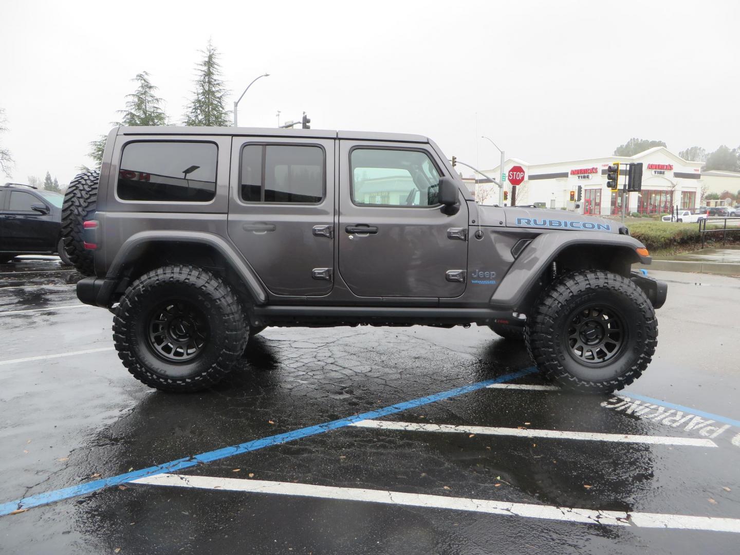 2021 CHARCOAL /BLACK Jeep Wrangler Unlimited Rubicon 4XE (1C4JJXR68MW) with an 2.0L L4 DOHC 16V HYBRID engine, 8A transmission, located at 2630 Grass Valley Highway, Auburn, CA, 95603, (530) 508-5100, 38.937893, -121.095482 - 4xe Rubicon sitting on a JKS suspension system, Fox shocks, 17" Method MR703 beadgrip wheels, 37" Toyo MT tires, and a Teraflex HD spare tire carrier. - Photo#3