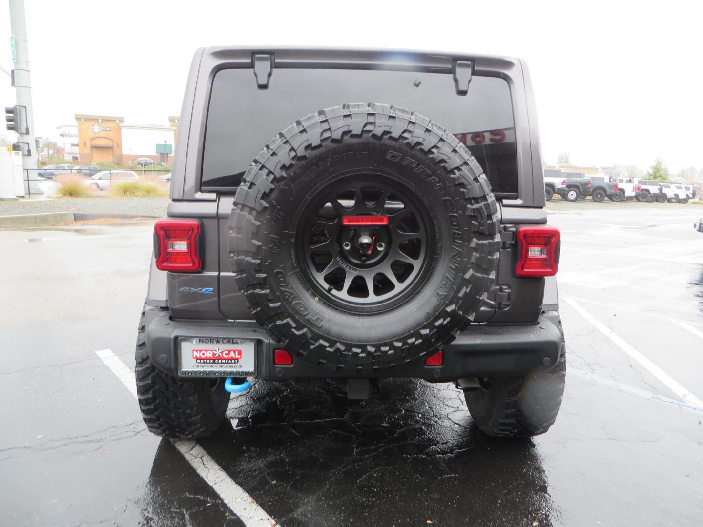 2021 CHARCOAL /BLACK Jeep Wrangler Unlimited Rubicon 4XE (1C4JJXR68MW) with an 2.0L L4 DOHC 16V HYBRID engine, 8A transmission, located at 2630 Grass Valley Highway, Auburn, CA, 95603, (530) 508-5100, 38.937893, -121.095482 - 4xe Rubicon sitting on a JKS suspension system, Fox shocks, 17" Method MR703 beadgrip wheels, 37" Toyo MT tires, and a Teraflex HD spare tire carrier. - Photo#5