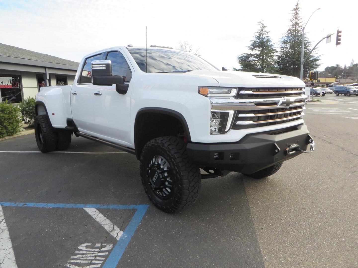 2022 White /Black Chevrolet Silverado 3500HD High Country Crew Cab 4WD (1GC4YVEY0NF) with an 6.6L V8 OHV 32V TURBO DIESEL engine, 6A transmission, located at 2630 Grass Valley Highway, Auburn, CA, 95603, (530) 508-5100, 38.937893, -121.095482 - Must see High Country Dually featuring a CST lift kit, 20" DDC wheels, Toyo Open Country RT Trail tires, Road Armor front and rear bumpers, Road Armor 12k Winch, Westin LED lights, and Window tint. - Photo#2