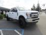 2019 White Ford F-250 SD XLT Crew Cab Short Bed 4WD (1FT7W2BT9KE) with an 6.7L V8 OHV 16V DIESEL engine, 6A transmission, located at 2630 Grass Valley Highway, Auburn, CA, 95603, (530) 508-5100, 38.937893, -121.095482 - Leveled XLT sitting on 22" SOTA Novakane wheels, 325 Nitto Ridge Grappler tires, Fox Shocks and dual steering stabilizers, Firestone Ride Rite air bags, Airlift wireless 1 air compressor, B&W Turnover gooseneck hitch, Weathertech floor liners, Deezee tailgate assist, and window tint. - Photo#2