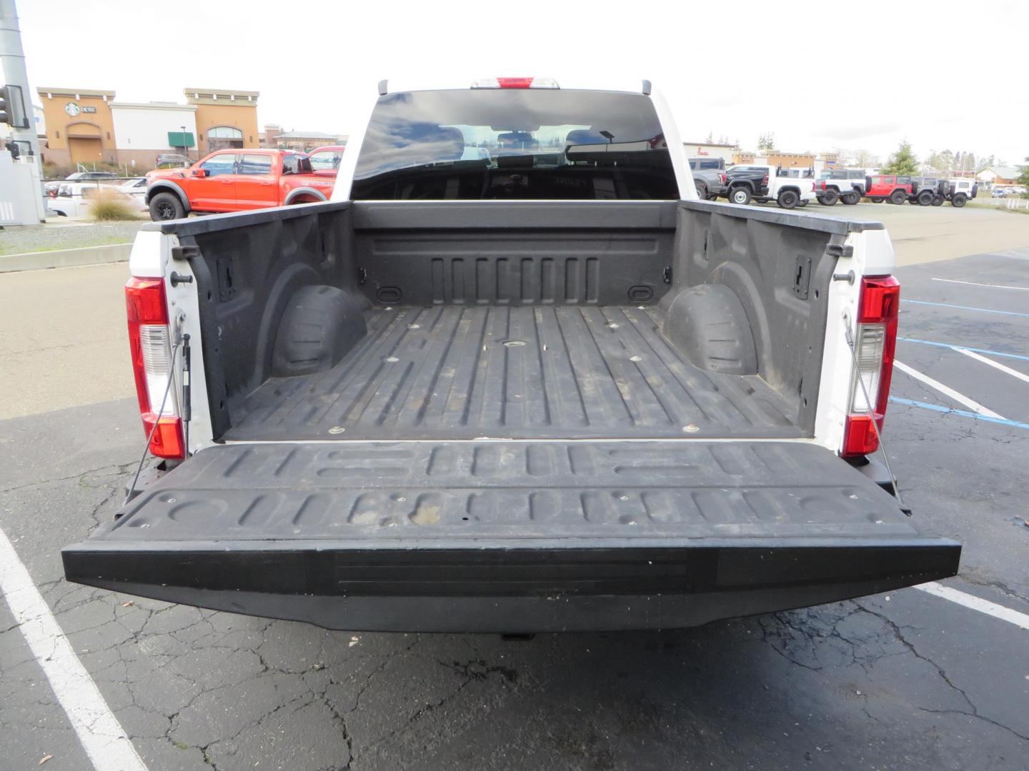 2019 White Ford F-250 SD XLT Crew Cab Short Bed 4WD (1FT7W2BT9KE) with an 6.7L V8 OHV 16V DIESEL engine, 6A transmission, located at 2630 Grass Valley Highway, Auburn, CA, 95603, (530) 508-5100, 38.937893, -121.095482 - Leveled XLT sitting on 22" SOTA Novakane wheels, 325 Nitto Ridge Grappler tires, Fox Shocks and dual steering stabilizers, Firestone Ride Rite air bags, Airlift wireless 1 air compressor, B&W Turnover gooseneck hitch, Weathertech floor liners, Deezee tailgate assist, and window tint. - Photo#15