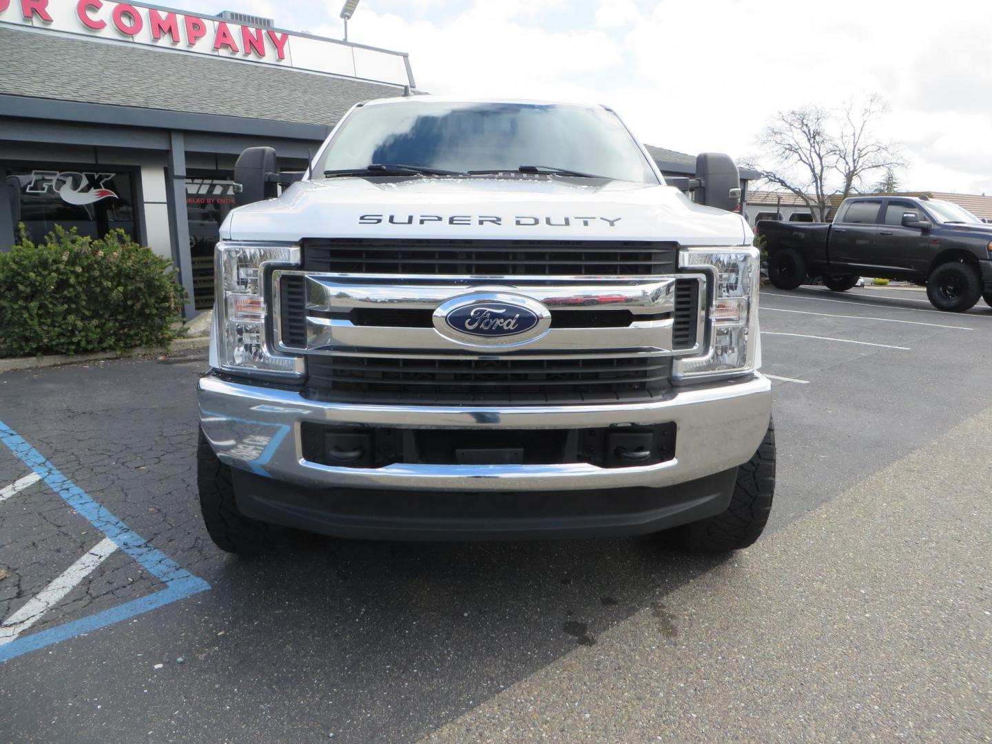 2019 White Ford F-250 SD XLT Crew Cab Short Bed 4WD (1FT7W2BT9KE) with an 6.7L V8 OHV 16V DIESEL engine, 6A transmission, located at 2630 Grass Valley Highway, Auburn, CA, 95603, (530) 508-5100, 38.937893, -121.095482 - Leveled XLT sitting on 22" SOTA Novakane wheels, 325 Nitto Ridge Grappler tires, Fox Shocks and dual steering stabilizers, Firestone Ride Rite air bags, Airlift wireless 1 air compressor, B&W Turnover gooseneck hitch, Weathertech floor liners, Deezee tailgate assist, and window tint. - Photo#1