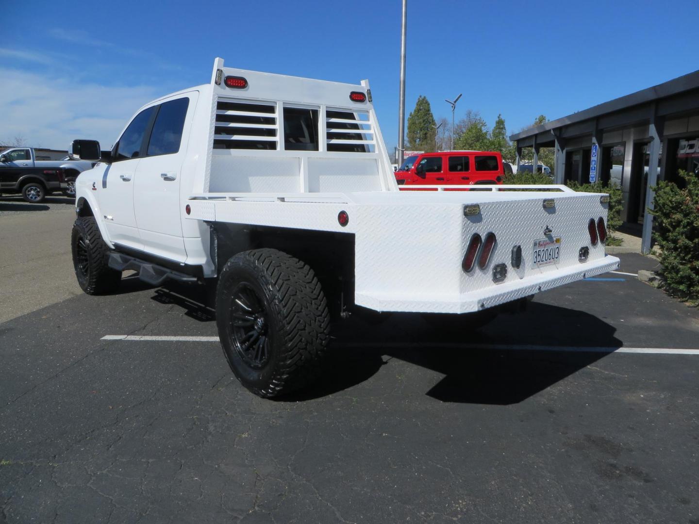 2022 White RAM 2500 Laramie Crew Cab SWB 4WD (3C6UR5FL5NG) with an 6.7L L6 OHV 24V TURBO DIESEL engine, 6A transmission, located at 2630 Grass Valley Highway, Auburn, CA, 95603, (530) 508-5100, 38.937893, -121.095482 - Custom Flat bed with emergency flashers and LED back up lights, Carli Suspension, 20" Fuel Rebel wheels, Fuel Gripper tires, Westin Running Boards, Air Bags, and window tint. - Photo#6