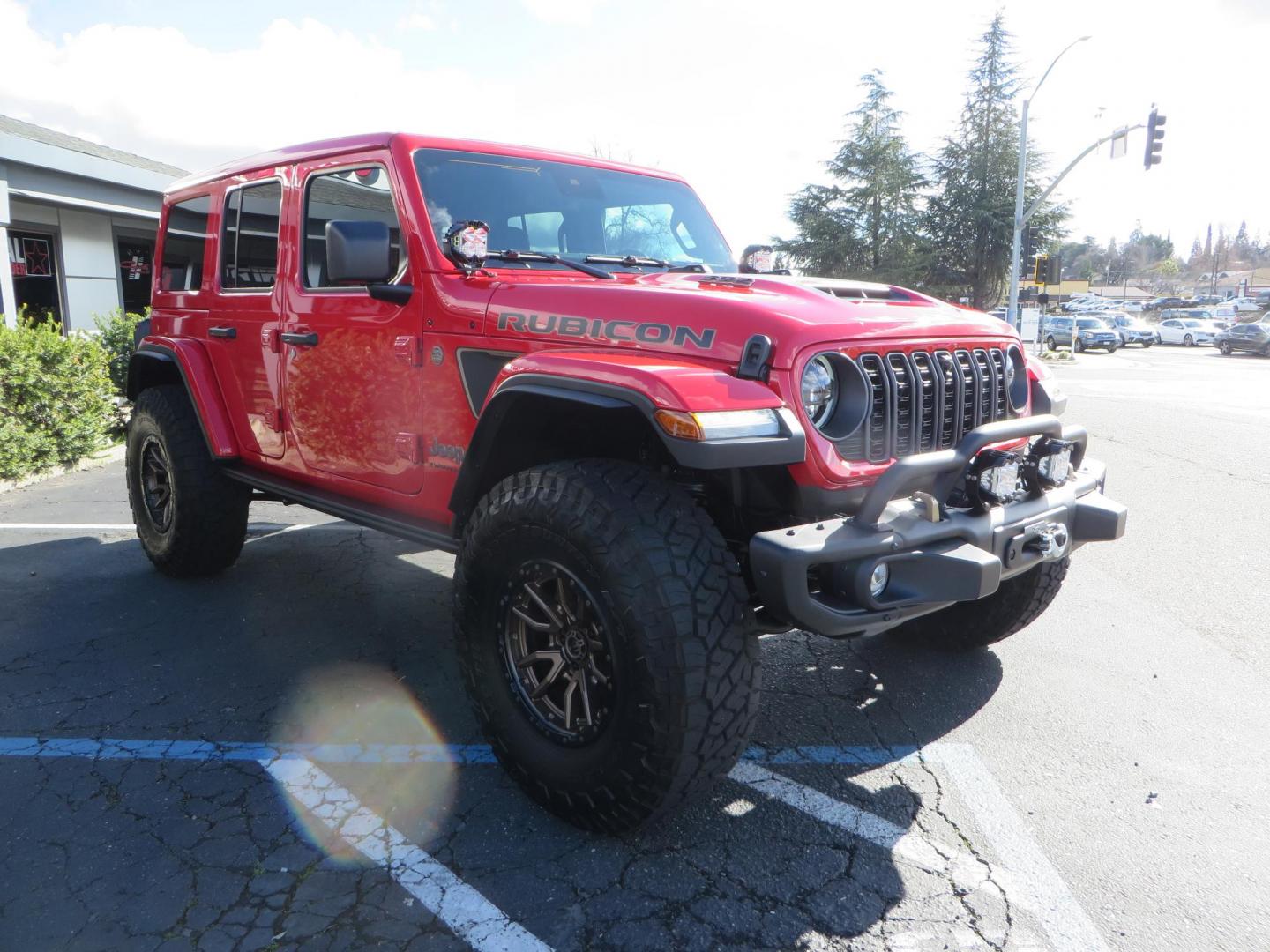 2024 Red /Black Jeep Wrangler Rubicon 392 (1C4RJXSJ3RW) with an 6.4L V8 DOHC 32V engine, 6M transmission, located at 2630 Grass Valley Highway, Auburn, CA, 95603, (530) 508-5100, 38.937893, -121.095482 - Final Edition Rubicon 392 with every option... Sitting on 17" Bronze Fuel Rebel wheels, 37" Toyo RT Trail tires, Baja Designs LP4 A pillar and bumper lights, paint correction before fully ceramic coated, PPF, and Ceramic window tint on front door glass and windshield. Sky One Touch Power top, Remova - Photo#2